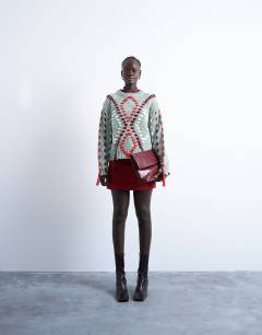 Model wearing Knitted argyle embroidered jumper in green