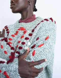 Model wearing Knitted argyle embroidered jumper in green