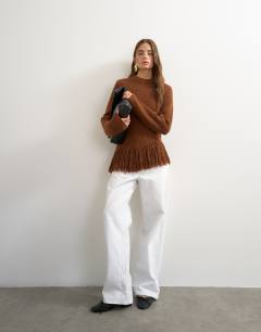 Model wearing Knitted asymmetric fringe jumper in gingerbread