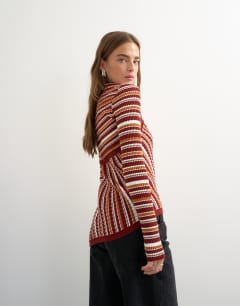 Model wearing Knitted asymmetric longline ribbed stripe top in red