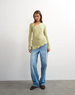 Model wearing Knitted asymmetric longline ribbed top in pistachio
