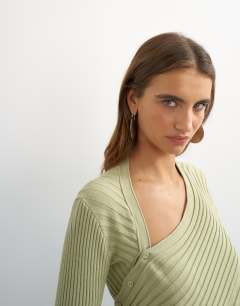 Model wearing Knitted asymmetric longline ribbed top in pistachio