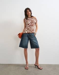 Model wearing Knitted asymmetric off shoulder animal print top in brown