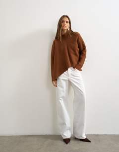Model wearing Knitted asymmetric panel jumper in gingerbread