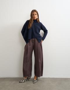 Model wearing Knitted asymmetric panel jumper in navy