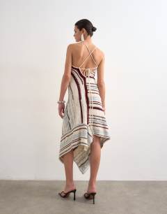 Model wearing Knitted asymmetric stripe full skirt dress in ecru