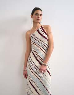 Model wearing Knitted asymmetric stripe full skirt dress in ecru