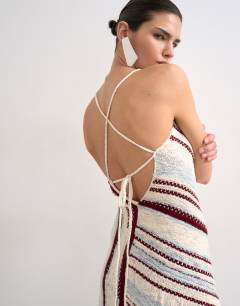 Model wearing Knitted asymmetric stripe full skirt dress in ecru