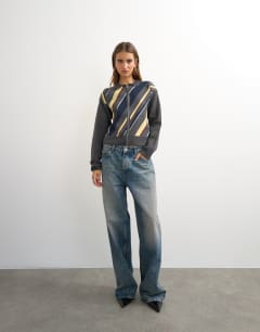 Model wearing Knitted asymmetric stripe jacket in grey multi