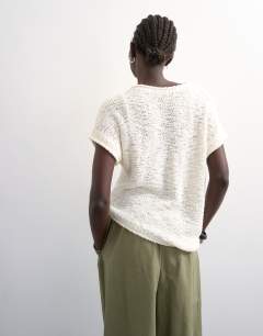 Model wearing Knitted asymmetric top in ivory