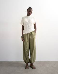 Model wearing Knitted asymmetric top in ivory