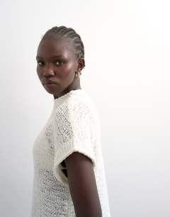 Model wearing Knitted asymmetric top in ivory