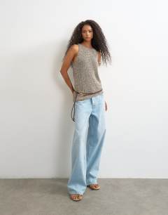 Model wearing Knitted asymmetric vest in khaki