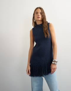 Model wearing Knitted asymmetrical fringe tunic in navy