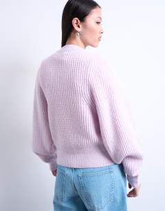 Model wearing Knitted balloon sleeve jumper in vailed pink