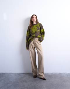 Model wearing Knitted blurred floral jumper in green
