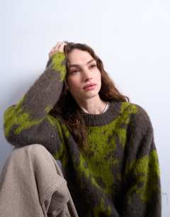 Model wearing Knitted blurred floral jumper in green