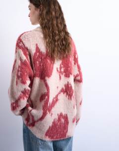 Model wearing Knitted blurred floral jumper in pink
