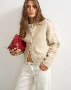 Model wearing Knitted boxy deep rib cardigan in latte