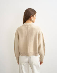Model wearing Knitted boxy deep rib cardigan in latte