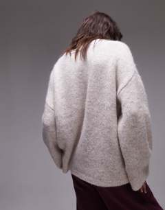 Model wearing Knitted boxy fluffy crew oversized jumper in oat