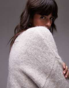 Model wearing Knitted boxy fluffy crew oversized jumper in oat