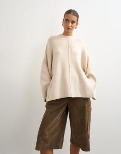 Model wearing Knitted boxy wide sleeve button detail jumper in latte