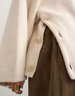 Model wearing Knitted boxy wide sleeve button detail jumper in latte