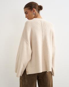 Model wearing Knitted boxy wide sleeve button detail jumper in latte