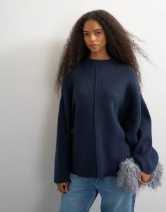 Model wearing Knitted boxy wide sleeve button detail jumper in midnight