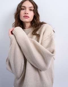 Model wearing Knitted boxy wide sleeve mid crew jumper in oat