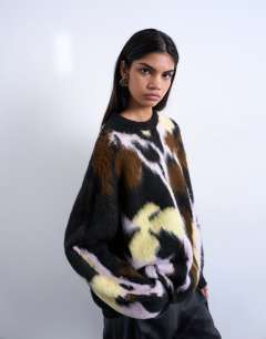 Model wearing Knitted brushed flower jumper in black