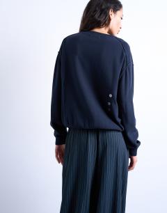Model wearing Knitted button back jumper in navy