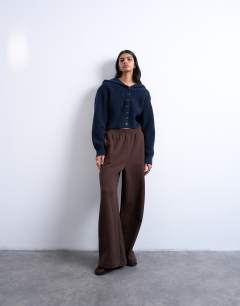 Model wearing Knitted button through shoulder padded hoodie in Navy