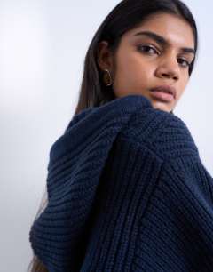 Model wearing Knitted button through shoulder padded hoodie in Navy