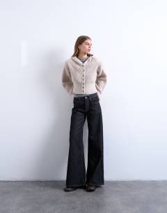 Model wearing Knitted button through shoulder padded hoodie in oat