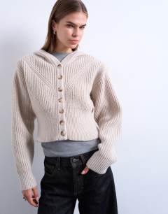 Model wearing Knitted button through shoulder padded hoodie in oat