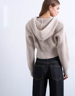 Model wearing Knitted button through shoulder padded hoodie in oat