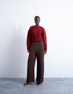 Model wearing Knitted cable fitted waist cardigan in burgundy