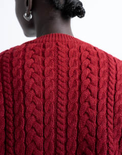 Model wearing Knitted cable fitted waist cardigan in burgundy