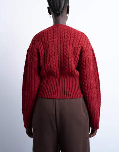 Model wearing Knitted cable fitted waist cardigan in burgundy