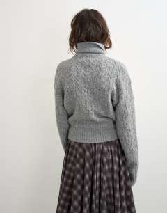Model wearing Knitted cable stitch funnel neck jumper in grey