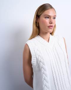 Model wearing Knitted cable v neck vest in ivory