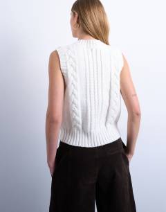 Model wearing Knitted cable v neck vest in ivory