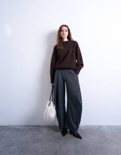 Model wearing Knitted chunky all needle clean crew jumper in chocolate