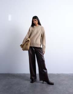 Model wearing Knitted chunky all needle clean crew jumper in oat