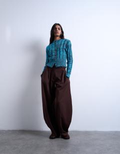 Model wearing Knitted chunky cinch waist twist cardigan in blue and chocolate