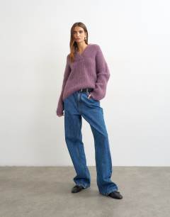 Model wearing Knitted chunky shawl collar jumper in bruised purple