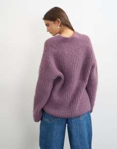 Model wearing Knitted chunky shawl collar jumper in bruised purple