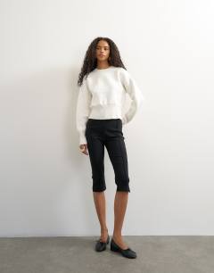Model wearing Knitted clean cinch waist batwing sleeve jumper in ivory